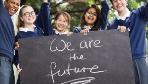 students holding a sign about the future